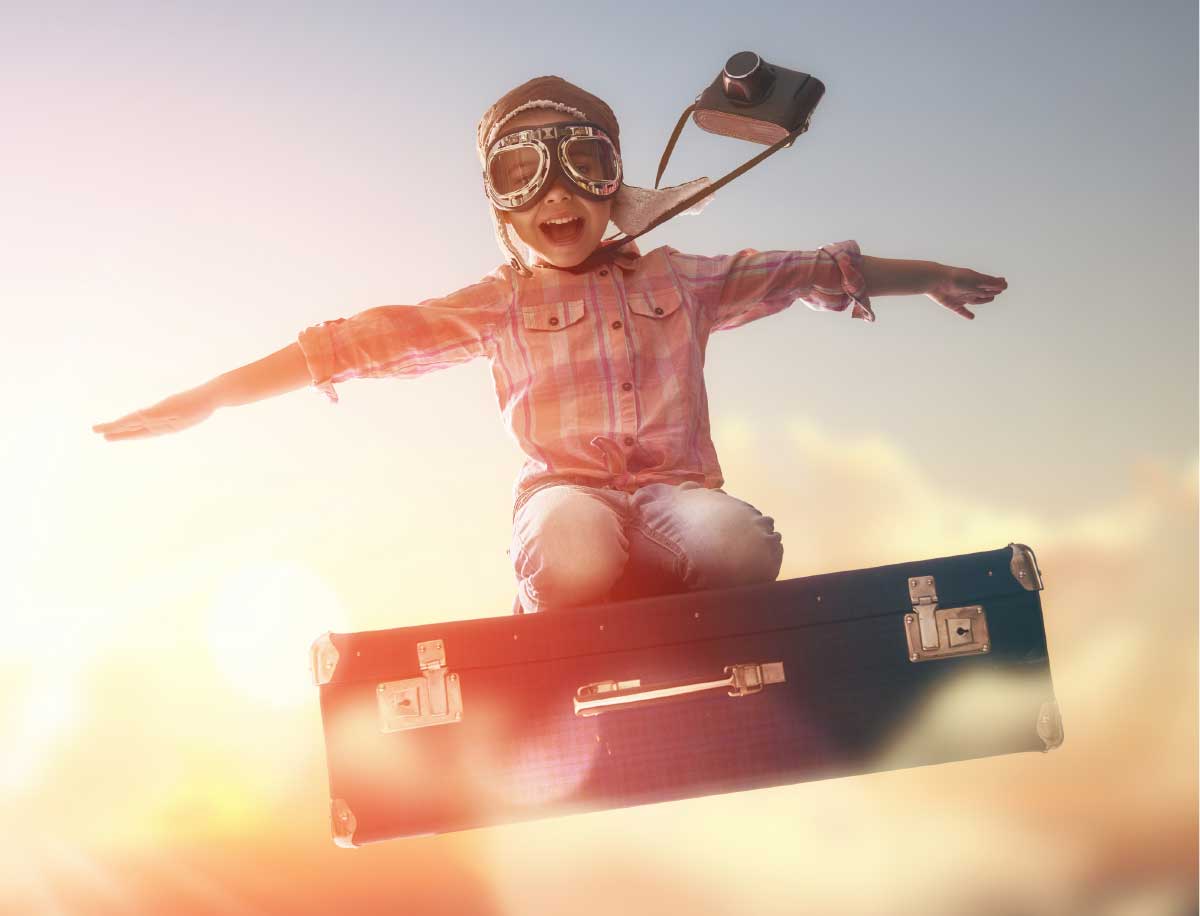 boy on flying suitcase
