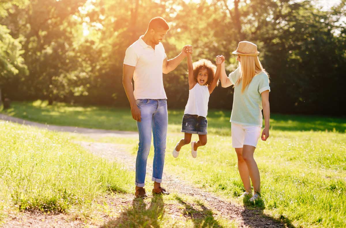 parents lift their child up